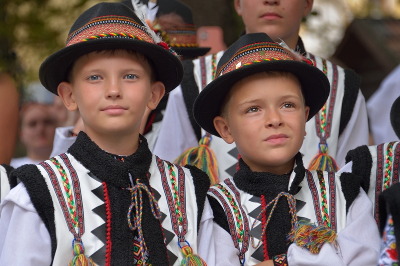 Deux jeunes garçons houtsoules portant des chapeaux et des costumes traditionnels brodés.